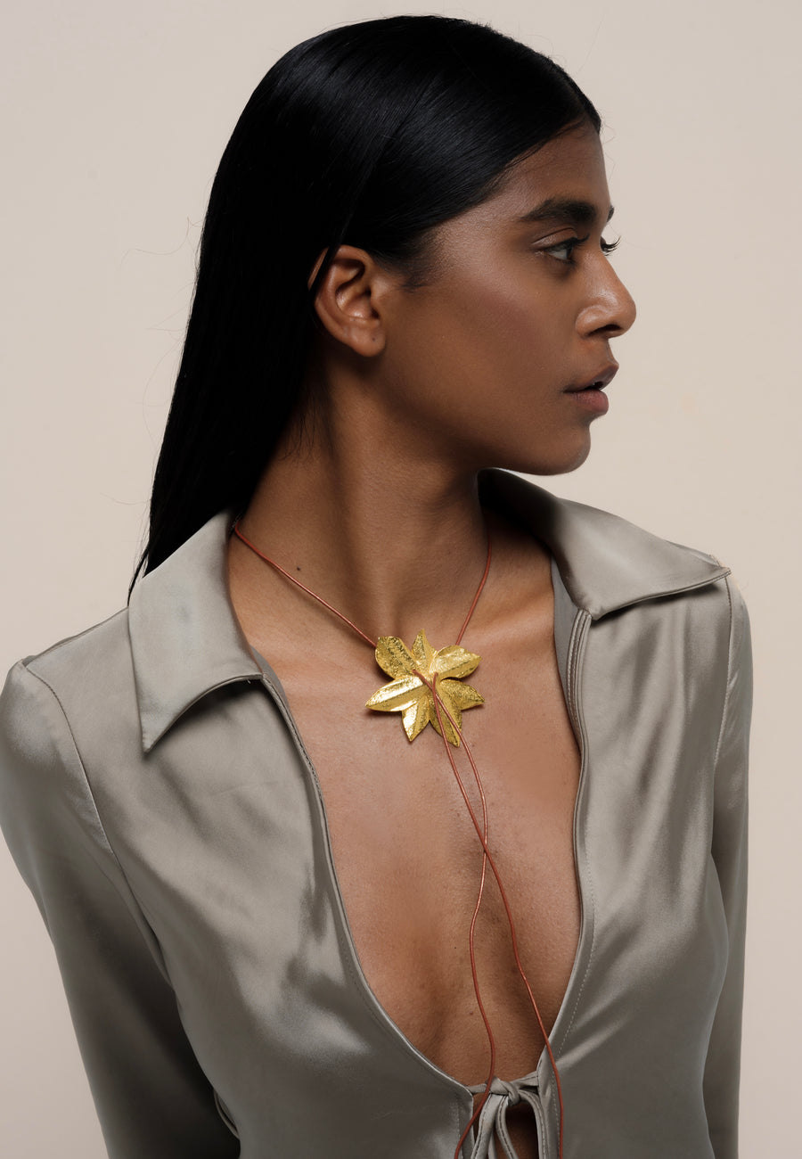 collar multiposición con cordón de cuero y flor de loto dorada