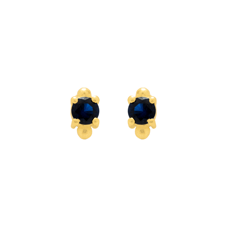Piercing pequeño decorado con una circonita azul y bañado en oro de 22 quilates.